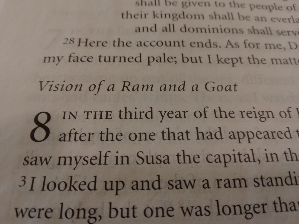 close up of bible page with the beginning of Daniel chapter 8. heading for chapter reads: "Vision of a Ram and a Goat"