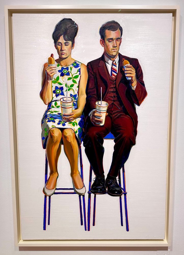 Painting of a man and a woman sitting uncomfortably on two stools holding soft drinks and looking dubiously at hotdogs.