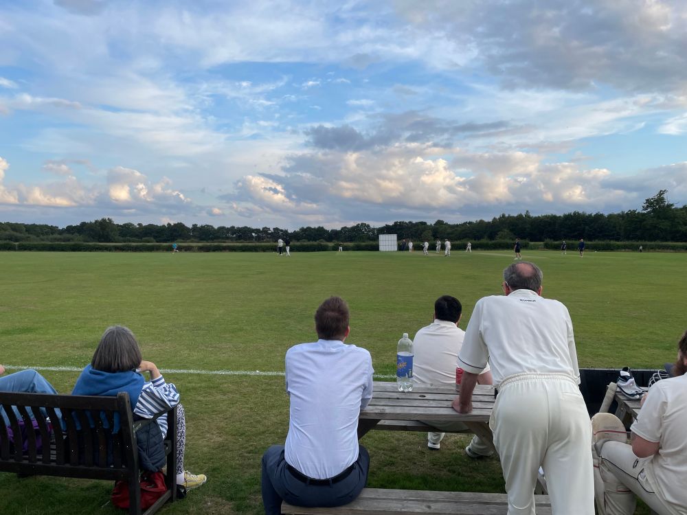 Watching our batting on a warm summer’s evening.
My Mum is sat on the left, my Dad is half-stood on the right.