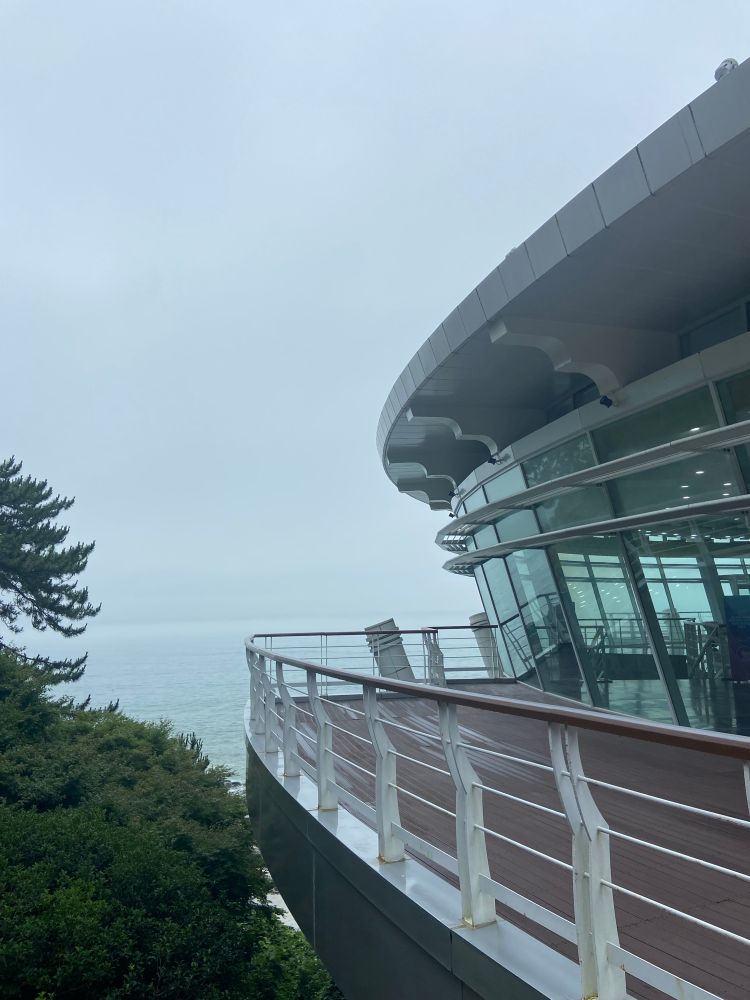A foggy background with the balcony of the Nurimaru APEC house in front  