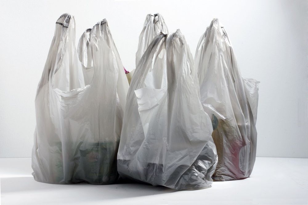 The image shows a group of standard thin plastic shopping bags, typically found at grocery or convenience stores. These bags appear to be partially filled and are loosely gathered at the top, likely tied or twisted.

If these bags are intended to be used to store gasoline, this would present extreme safety hazards, including:

    Structural integrity: These bags are not designed to contain liquids, especially volatile ones like gasoline. They will likely rupture or leak.

    Chemical incompatibility: Gasoline can degrade or dissolve certain plastics, leading to leakage and fume emission.

    Fire and explosion risk: Gasoline is highly flammable. Any leakage in a poorly ventilated area can cause vapor accumulation, creating an explosion hazard.

    Legal and environmental violations: Storing gasoline in unauthorized containers is illegal in many jurisdictions and poses serious environmental risks.

    Conclusion: These bags are not safe for gasoline storage under any circumstances. Approved fuel containers with proper seals, venting mechanisms, and material ratings (e.g., DOT-approved gas cans) must be used instead.