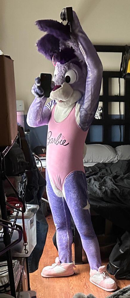 Twilight bunny in purple/white fur petsuit and pink Barbie swimsuit, taking a full body mirror selfie. Arm held overhead 