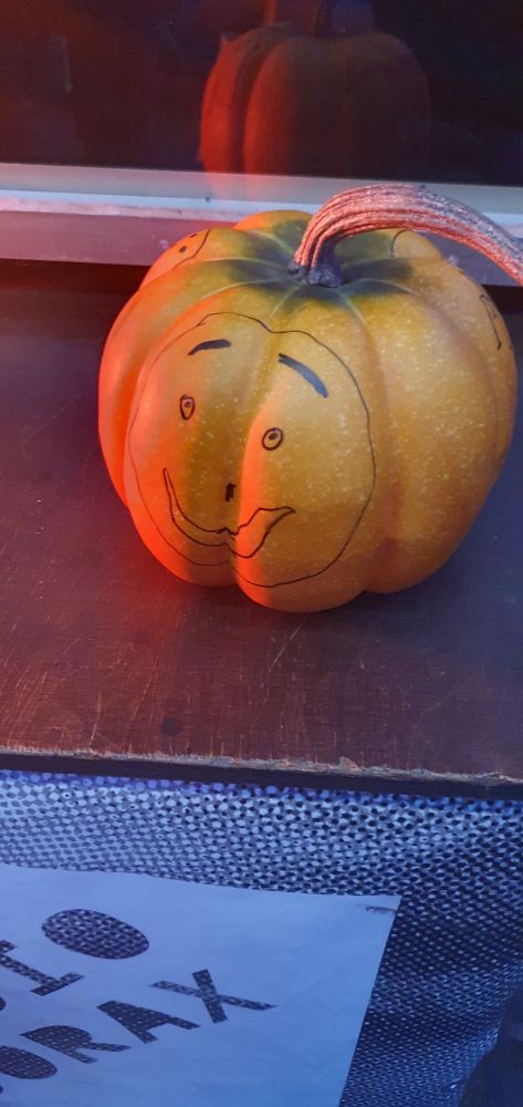 Ein Kürbis mit einem aufgemalten Gesicht.