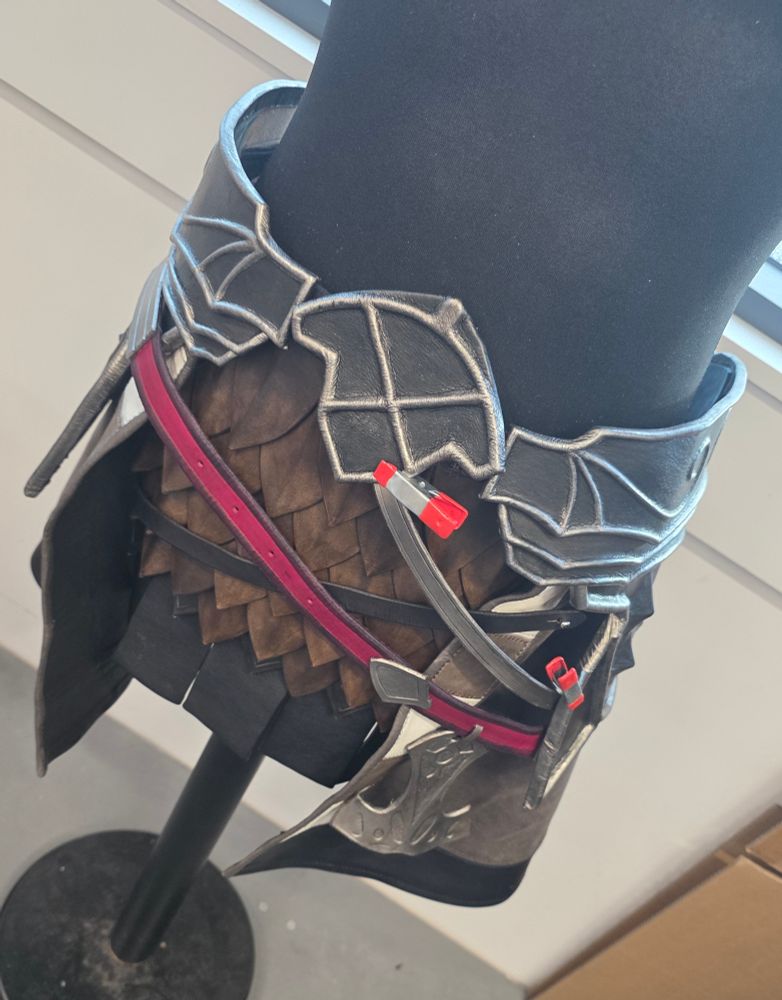 A work in progress snapshot of an Ardbert cosplay from Final Fantasy XIV. This includes his tassets, underskirt layers, hip armour and belts with charms. It is completely hand made from leather and clamps are holding a few pieces together temporarily. 
