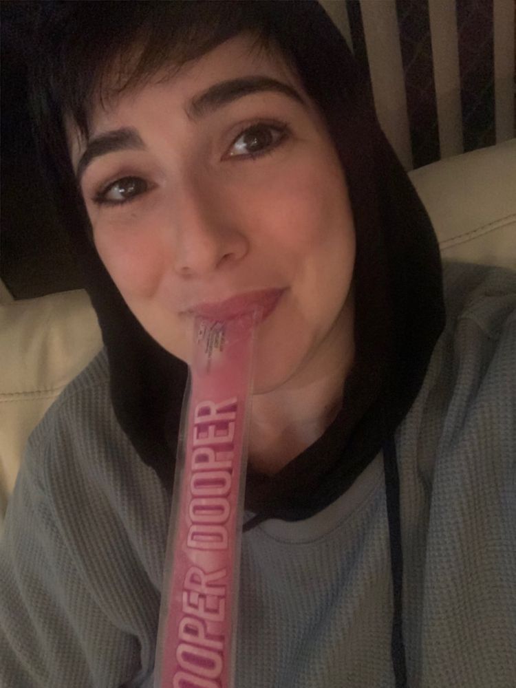 A tearful woman enjoying a pink zooper dooper