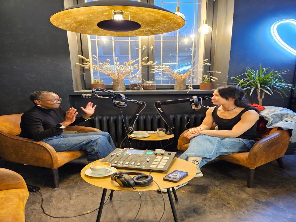 Photo of podcast host and guest chatting in cafe 