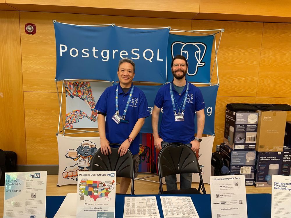 Mark Wong and Jacob Champion at the PostgreSQL booth at FOSSY