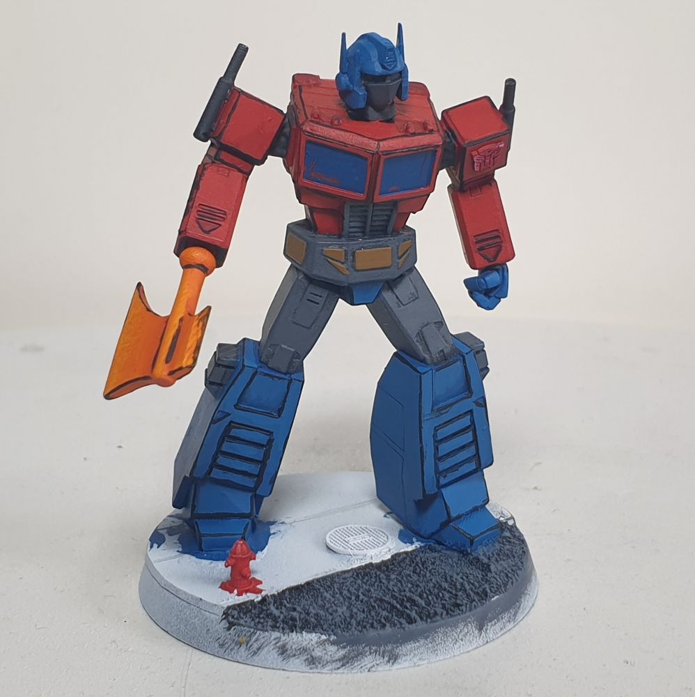A close up of the partially painted model of Optimus Prime in his bot form.
Mostly still only in base, block colours, though his arms and legs have received some black lining.