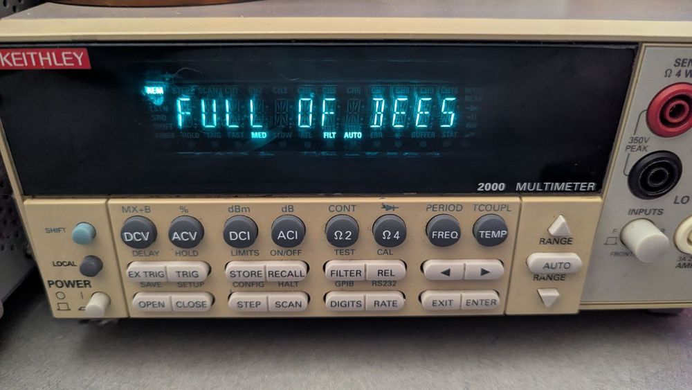 A photo of a kinda grimy Keithley 2000 with the text "FULL OF BEES"