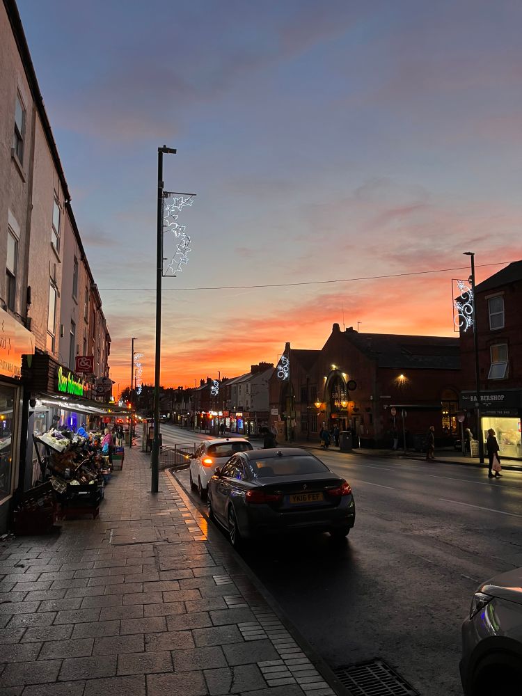 Ordinary street with Christmas decorations and a sunset 