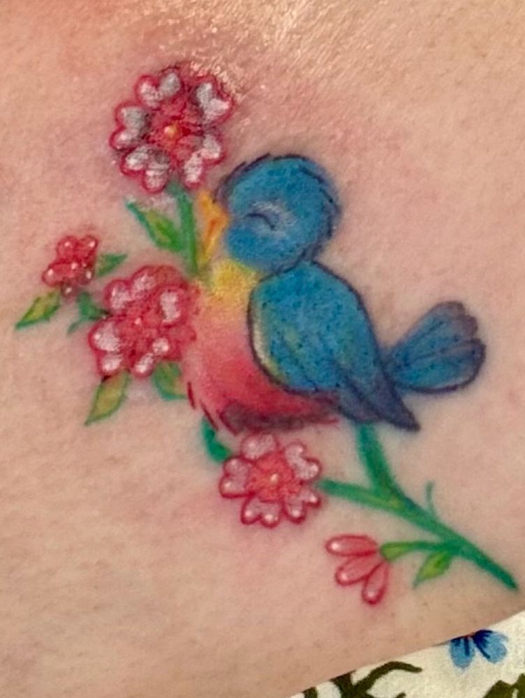 A retro (1940s style) brightly-colored bluebird sings happily while perched on a cluster of pink and white flowers