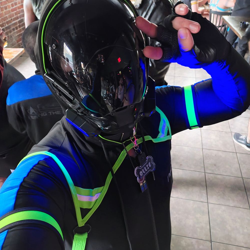 Selfie of myself in full Lycra and cyberpunk mask doing a peace sign.