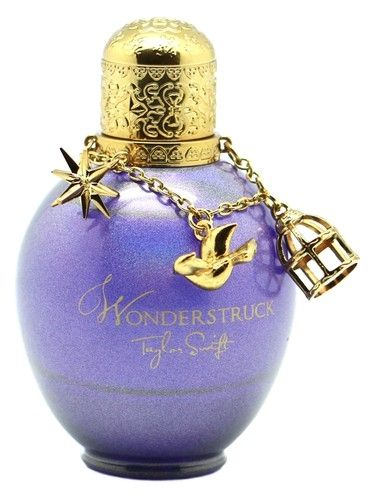 Picture of the "Wonderstruck" by Taylor Swift perfume bottle which is sparkly purple and a golden cap with a golden chain with charms of a star, a bird and a cage