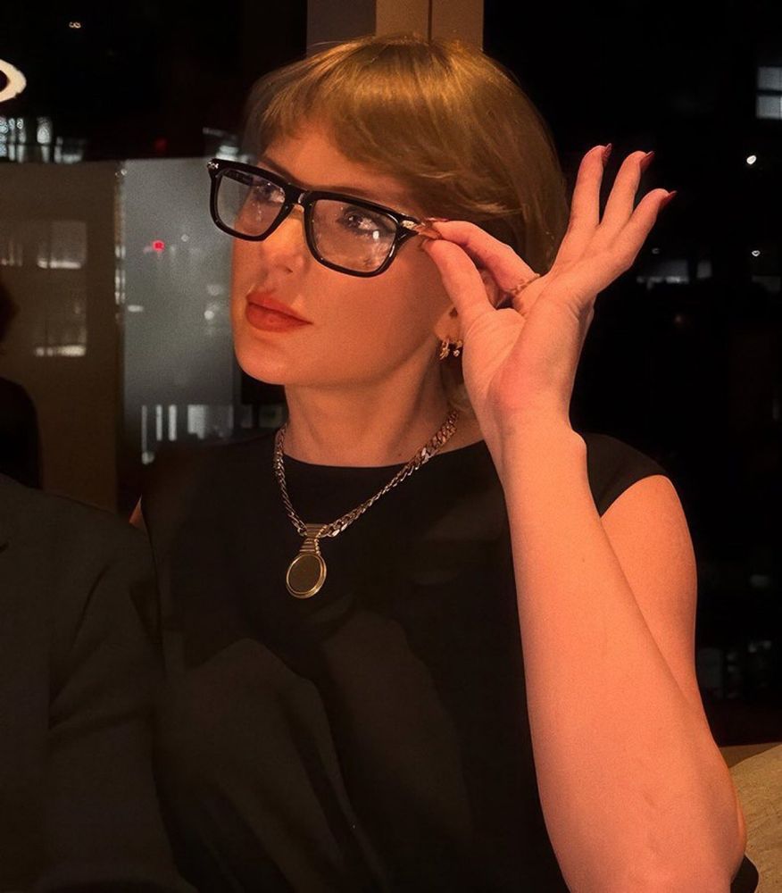 Taylor Swift wearing rimmed clear glasses