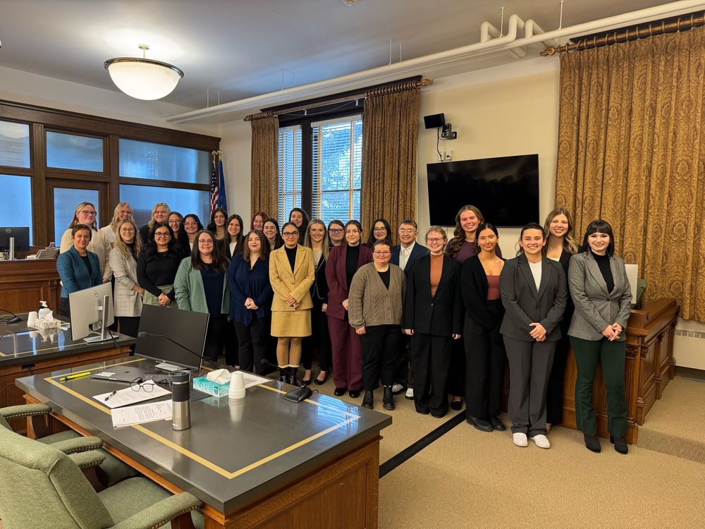 Group of people standing in a court room
