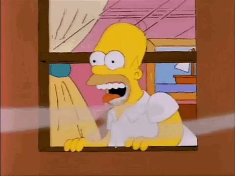 homer simpson is looking out of a window with his mouth open and a carrot in his mouth .