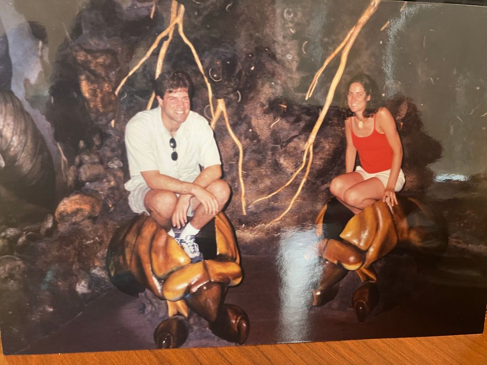 A man and a woman inside a cicada exhibit.