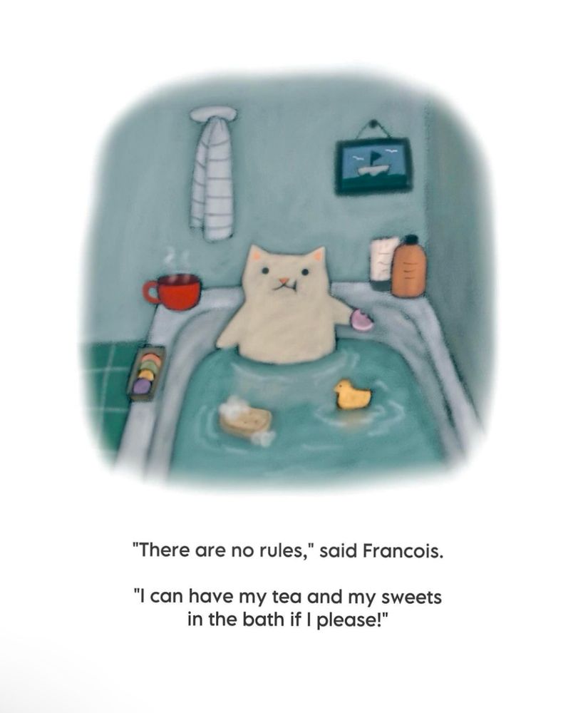 A cat soaking in the bath with shampoo and conditioner to the right, a cup of tea in a red cup steaming to the left, a box of Macarons on the side of the bath and a rubber ducky and a sponge floating in front of the cat. The caption reads: “There are no rules,” said François. “I can have my tea and my sweets in the bath if I please!”