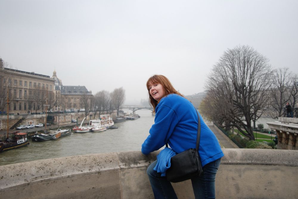 Jumping off the Pont Neuf in Paris. Lisa and her very well worn blue jumper, blue jeans stepping up on the ledge and pretending she’s going to jump off the bridge into the Seine.