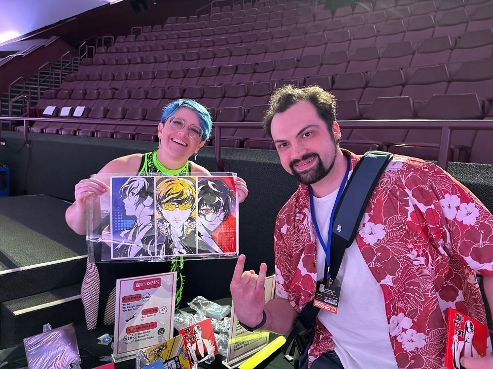 Me and Lacey holding a Persona poster with the protags from P3-P5 shown