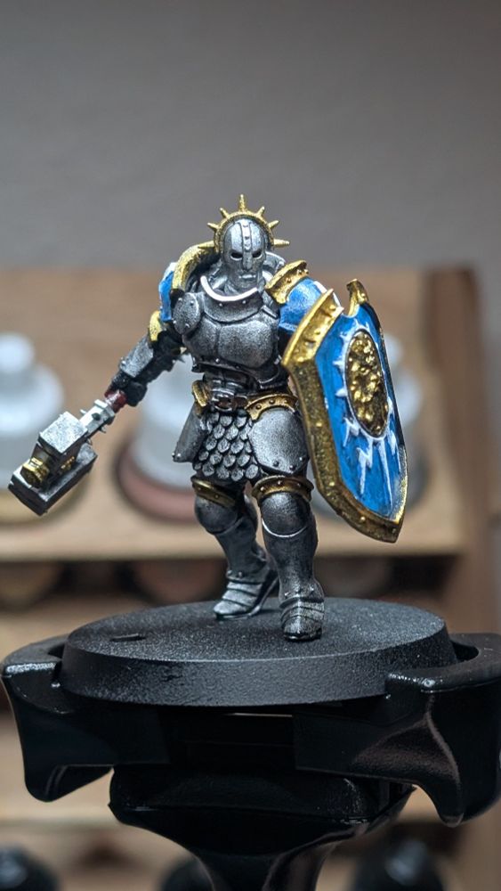Stormcast Eternals Liberator miniature painted silver with gold trim and blue accents.