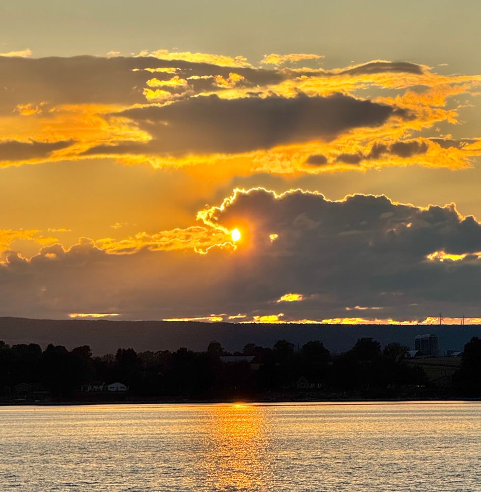Treadwell Bay at sunset with dramatic clouds and orange water.