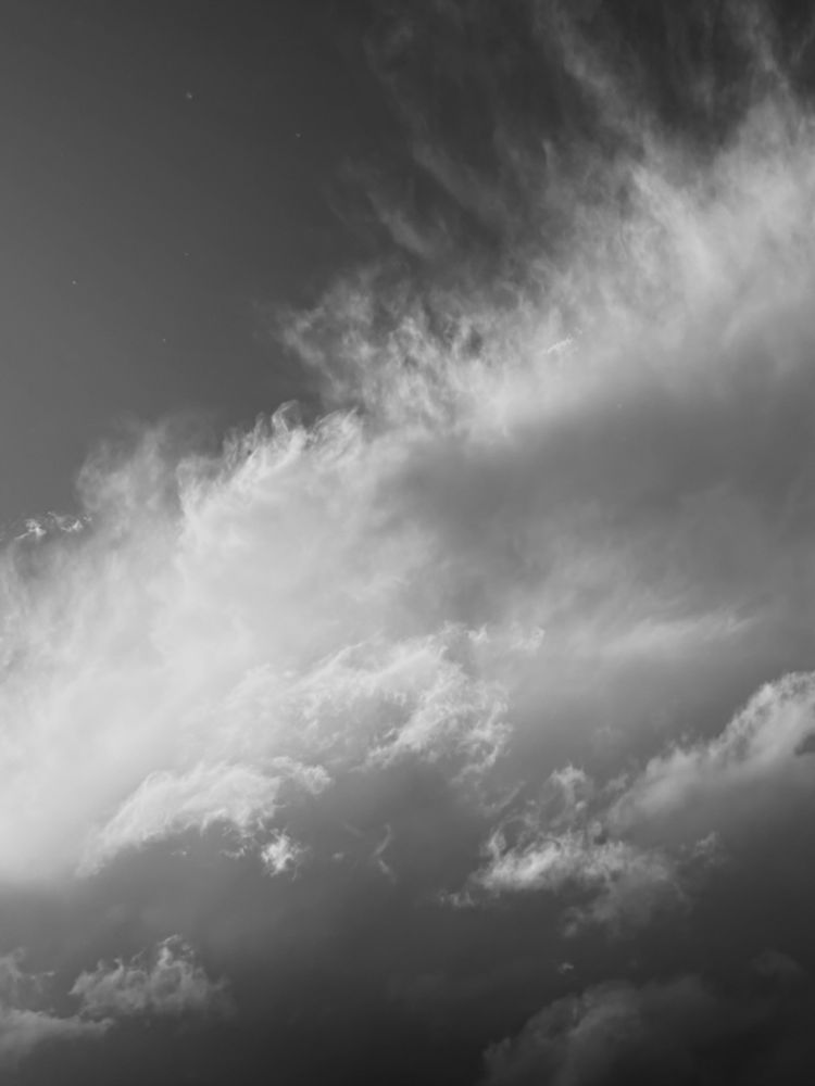 A black and white image of light and clouds