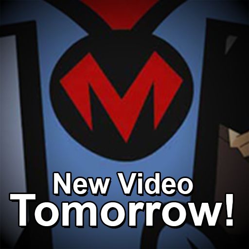A closeup of an emblem on a superhero's chest. It's a red "M." Text below reads "New Video Tomorrow."