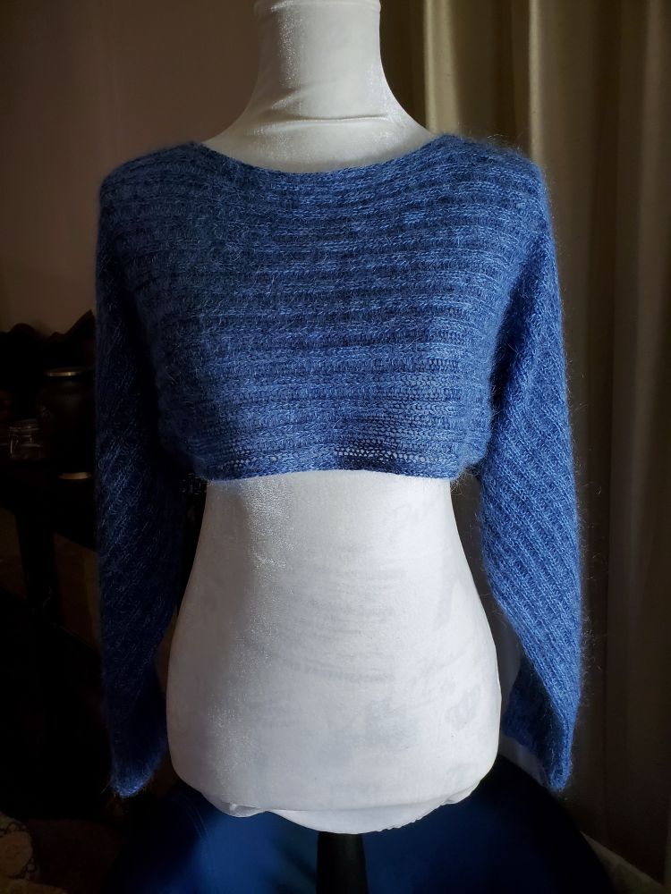 blue ribbed knit armwarmer on white mannequin. pattern is weekend armwarmer by svetlana volkova on ravelry yarns I used are discontinued 
#knitting 