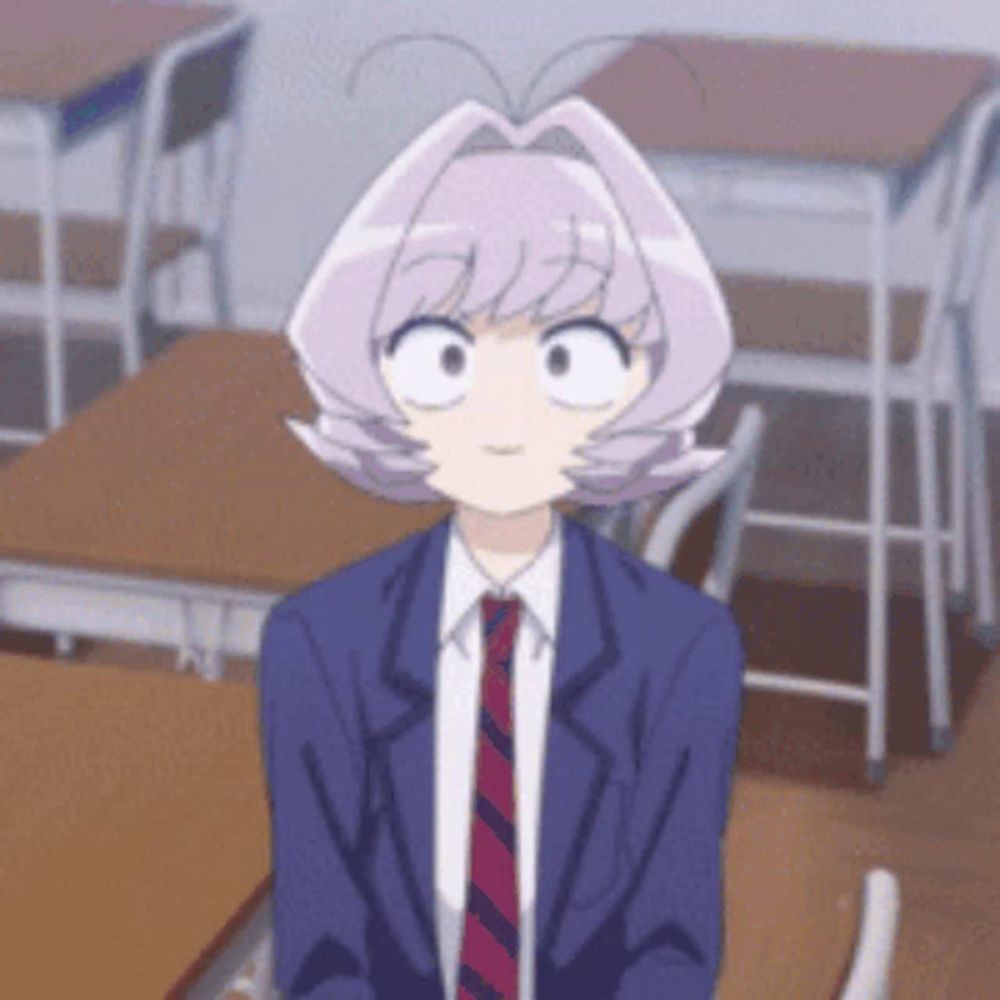 a girl with purple hair is sitting at a desk in a classroom