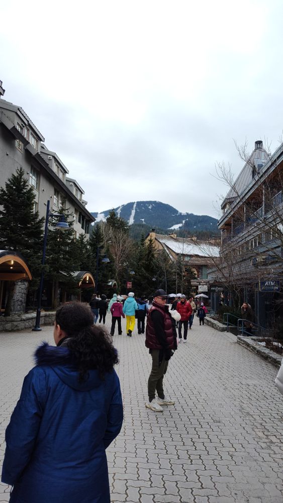 Partial view of the city of Whistler in BC with people walking around carefree