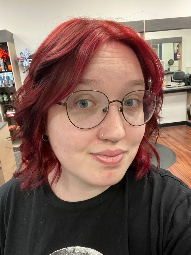 Op with red shoulder length curled hair