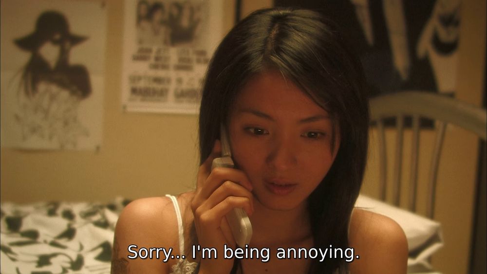 screencap of a girl on the phone in her bedroom, looking down at the floor. the subtitle reads "Sorry... I'm being annoying."