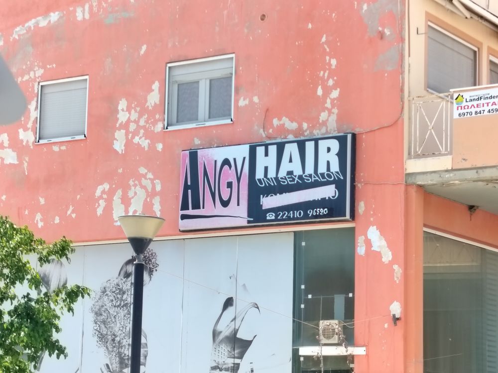 A sign for "Angy Hair Unisex Salon"