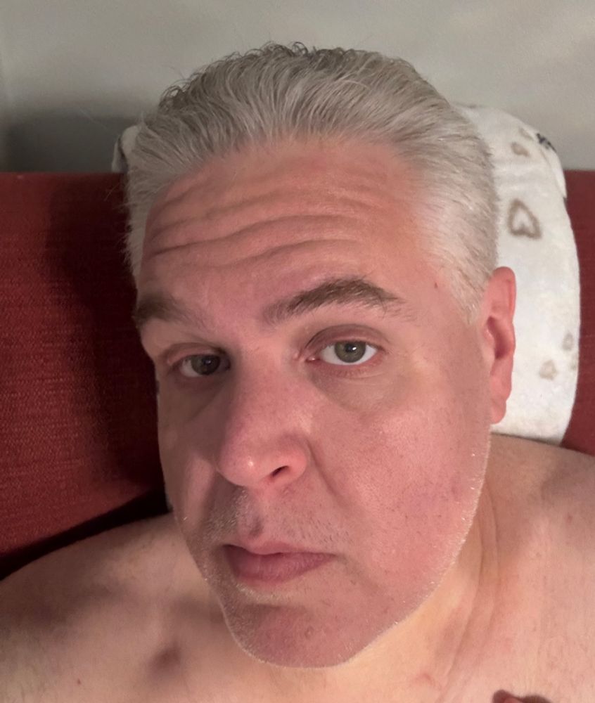 A mostly face selfie of me, a middle aged white dude with short gray and white hair. I’m making sexy eyes? Kinda? I don’t know.