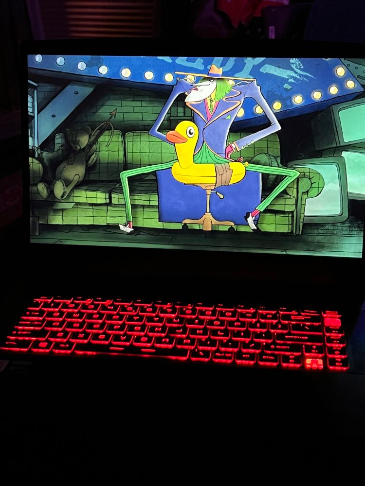 A stylistic cartoon The Joker sitting on a blow up duck rolly chair with the head of the duck merging from between his spindly legs