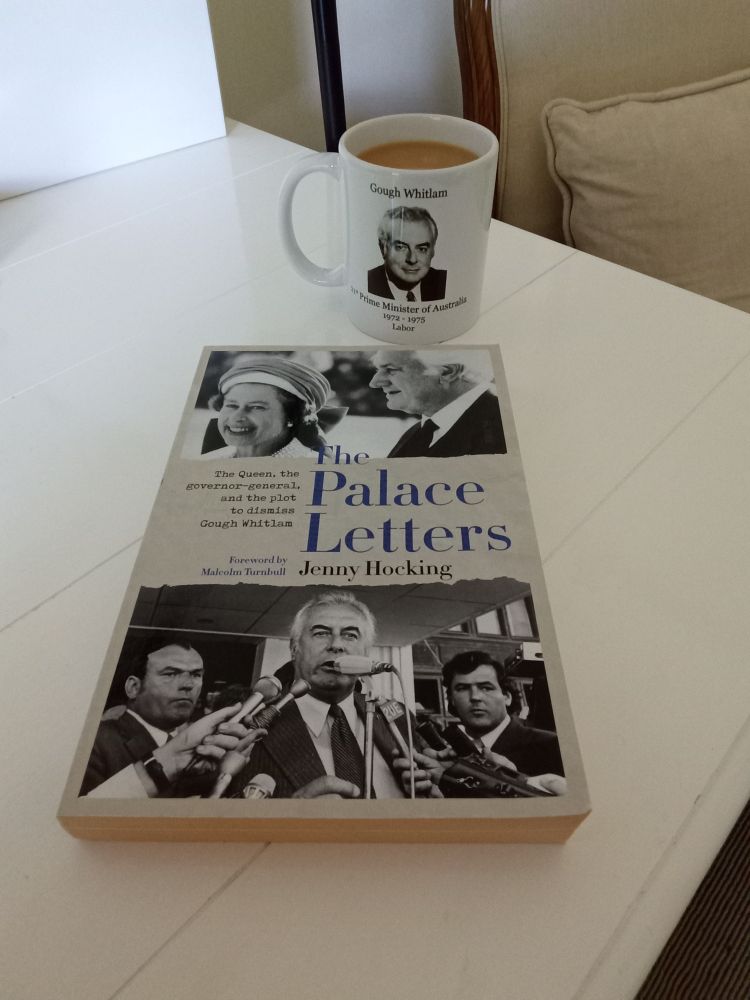 A desk photo of commemorative mug (with hot tea) showing years of Gough Whitlam's years as Prime Minister, & definitive account of the plot to dismiss him as PM.