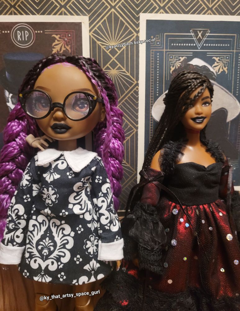 Close up of a rainbow high Lilac customized to have a Wednesday Addams dress. A customized curvy black doll wearing a red and black vampire outfit. An art deco background.