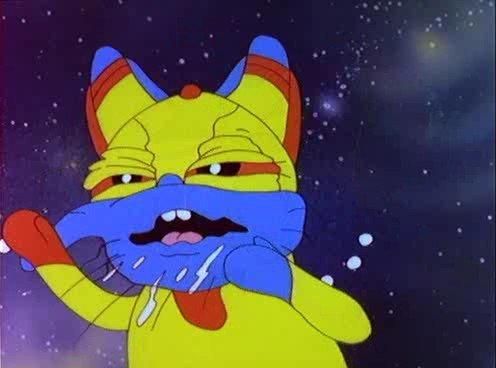 Indrikis XIII from Latvian cartoon Fantadroms. He is a weird-looking robot cat-thing that is colored with primary colors. It looks like he is sneezing or something, I don't know; it is clear he's having a bad time.