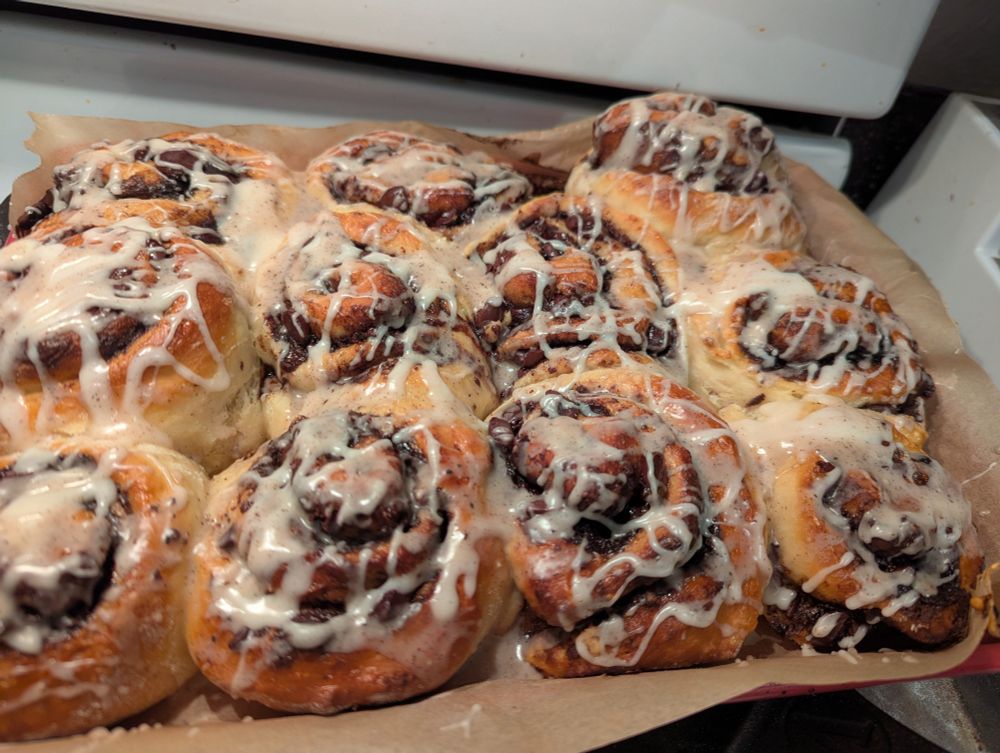 A tray of chocolate rolls with icing