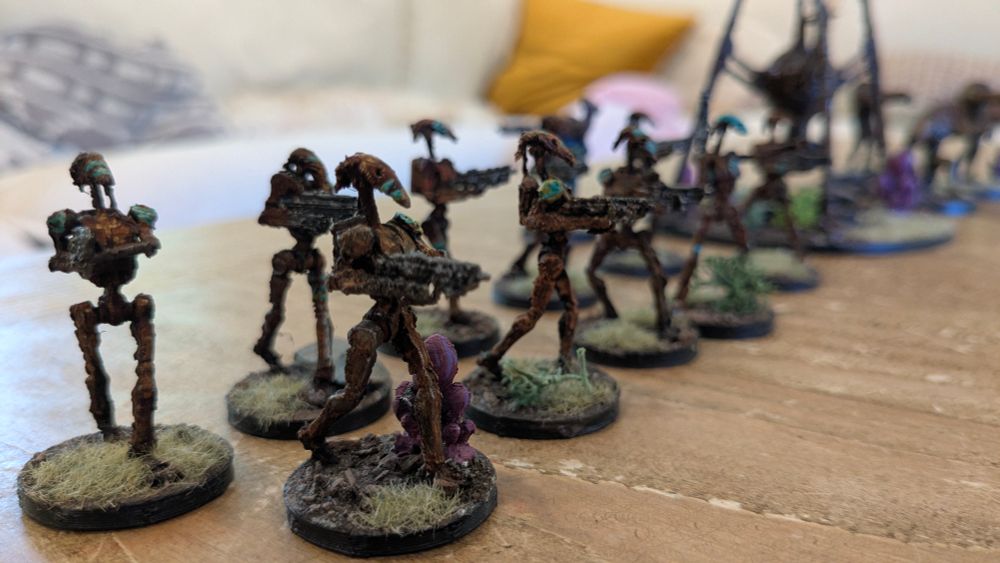 All images are of miniature Star wars battle droids, painted in a rusty color scheme with blue war paint 