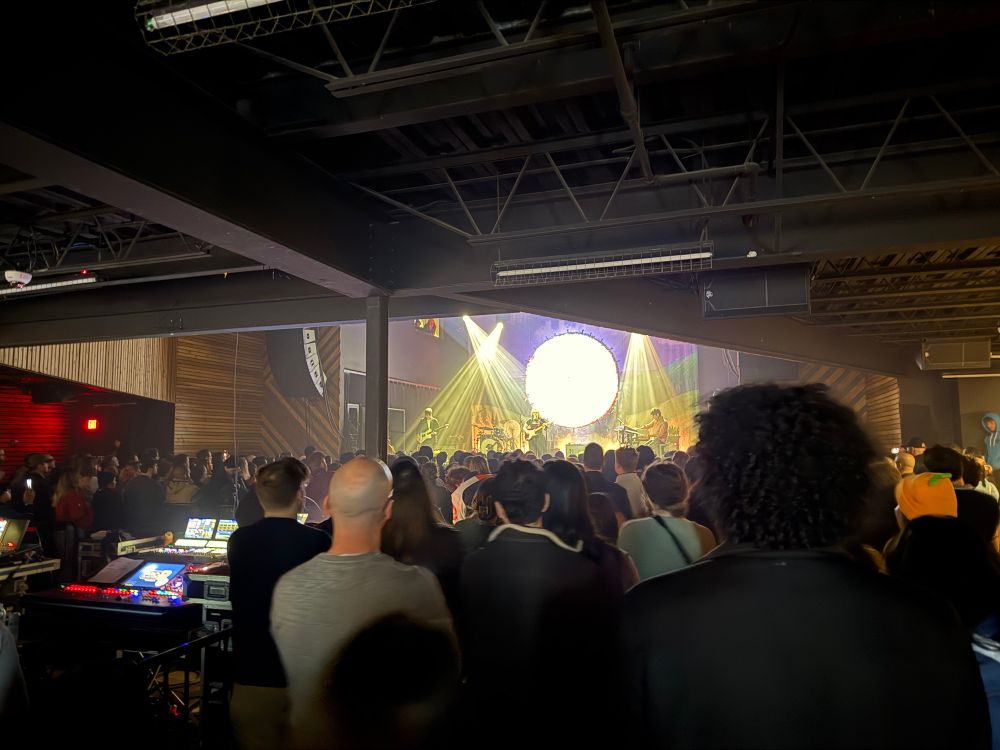 A picture from the back row of a venue watching Soccer Mommy perform on stage.