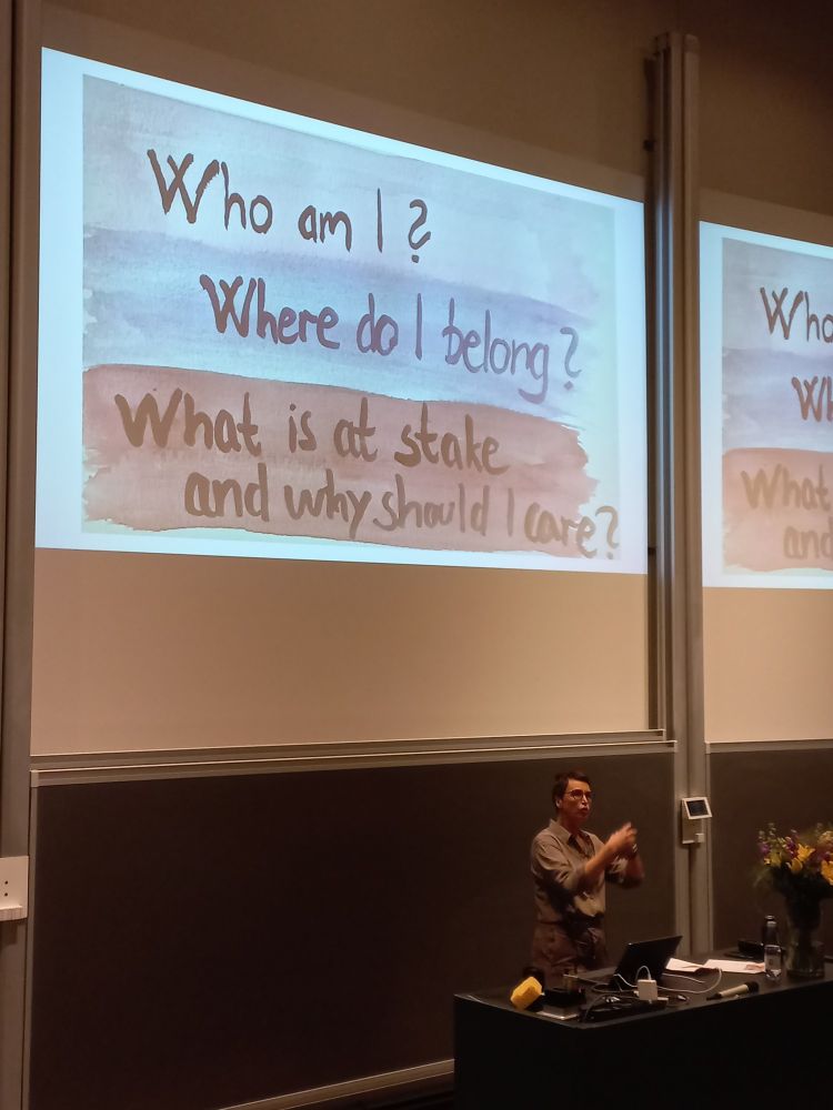 Elin Sæther presenting and a slide with three questions: Who am I? Where do I belong? What is at stake and why should I care?