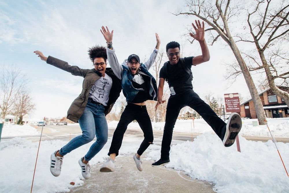 3 people jumping in the air