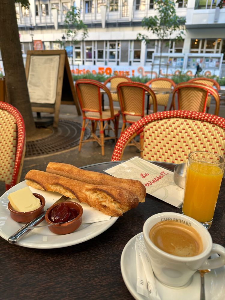 Coffee / Baguette / Butter & Jam / Orange juice on a typical Parisian café terrasse