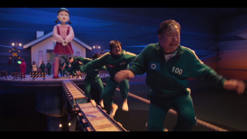 Players on the narrow platform exhaustedly jumping for their lives during the jump rope scene.