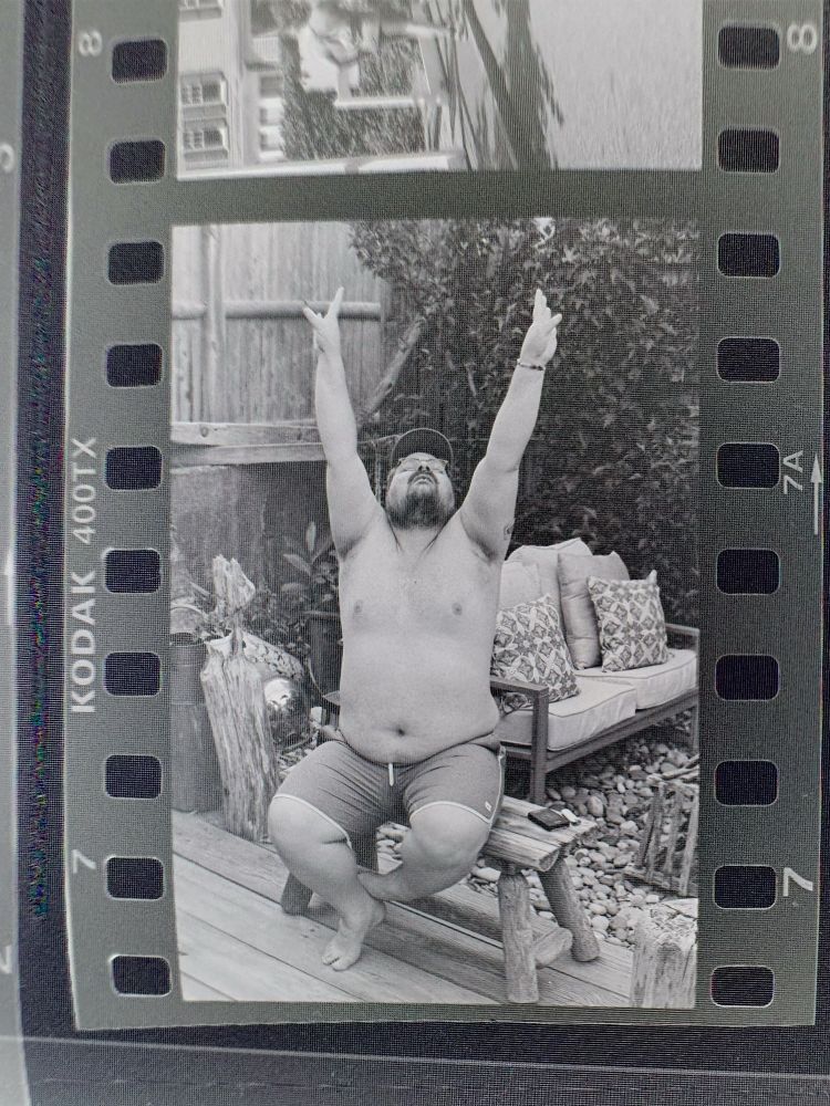patrick reached for the sky while sitting on a rickety wooden bench on the back patio of our Provincetown vacation rental  