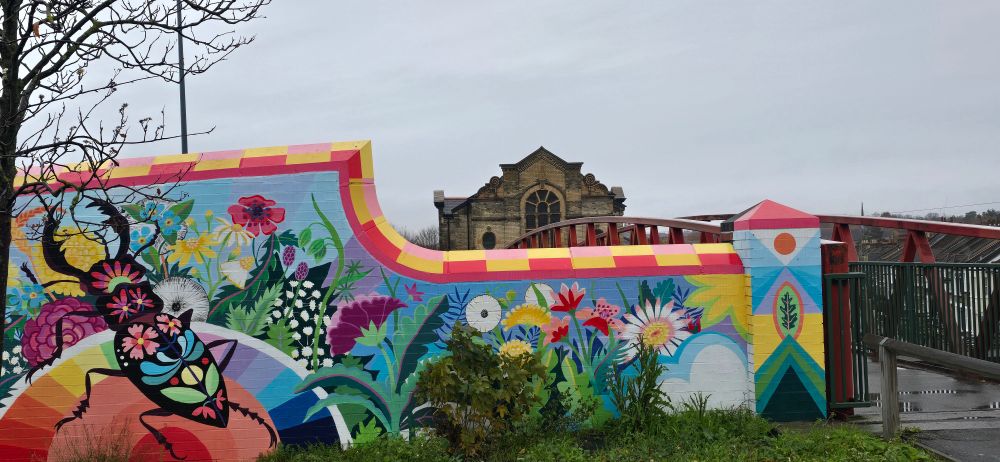 Old church - Leyton, London.  Bridge over motorway covered floral paintings.