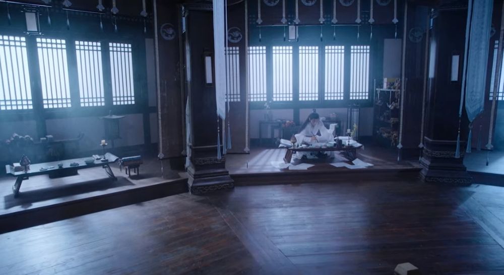 Wide shot of the Cloud Recesses library, Wei WuXian sitting by a table
