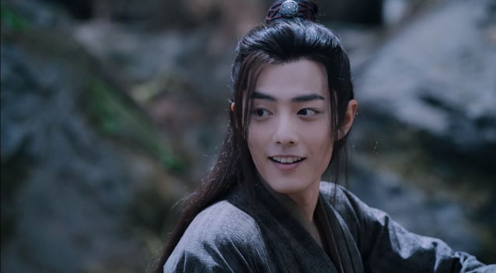 Closeup of Wei Wuxian (actor Xiao Zhan) (in black robes) smiling.